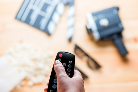 against the backdrop of the film industry objects close-up of TV remote in a female handの写真素材