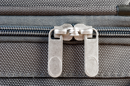 close-up two zipper runner buttoned gray suitcase macroの写真素材
