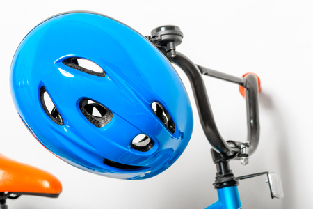 blue helmet for children on the handlebars of a children's bicycle close-upの写真素材
