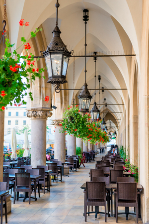 beautiful street cafe, located in the arch of shopping arcades in the center of Krakow in the squareの写真素材
