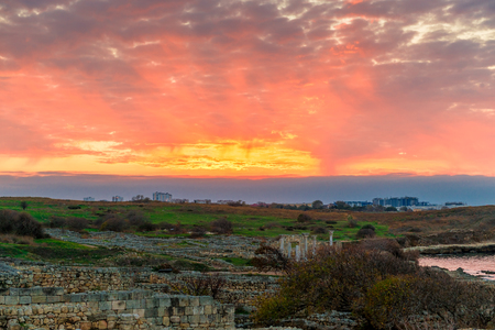 Sunset, beautiful orange sky over Ancient Chersonesos in Crimea, Russiaの写真素材