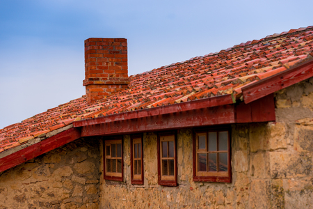 roof of a rural house close up against blue skyの写真素材