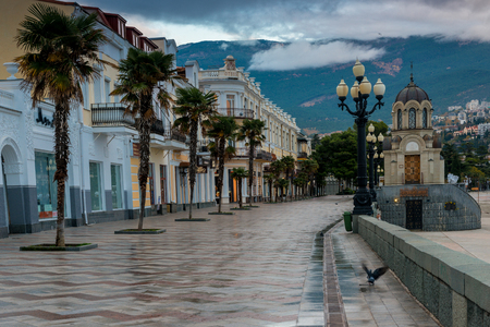 Embankment of the Russian city of Yalta in the autumn afternoon, view of the city and mountainsの写真素材