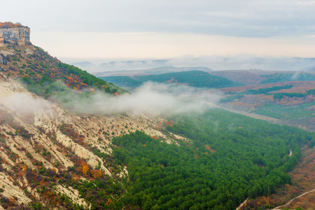 View from the mountain to the valley, shooting on a cloudy autumn dayの写真素材