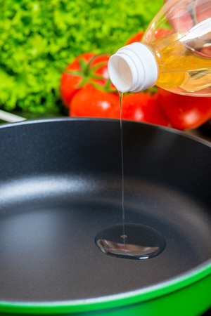 close-up hot pan, which is poured sunflower oil for cookingの写真素材