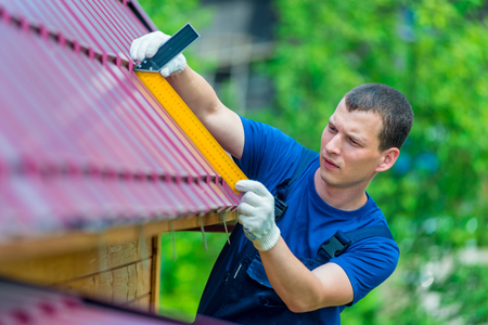 Professional worker repairs the roof of a residential buildingの写真素材