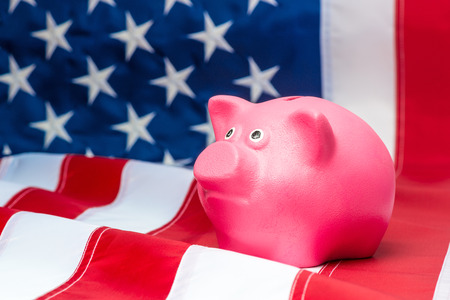 American flag and pink piggy bank close upの写真素材