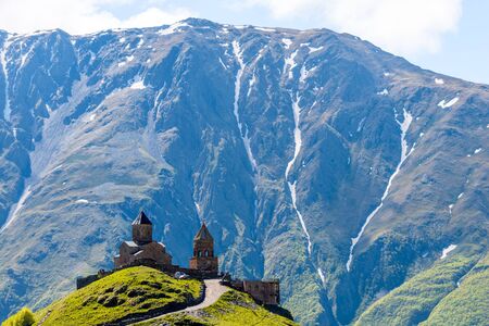 Orthodox Trinity Church in the village of Gergeti against the backdrop of the mountains, Caucasus,...