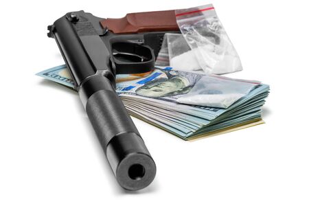 crime concept - a pistol with a silencer, money and drugs close upの写真素材