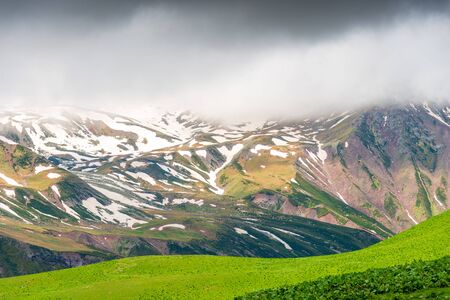 Scenic mountains with snow in June, Caucasus landscape on an overcast day, Georgiaの写真素材
