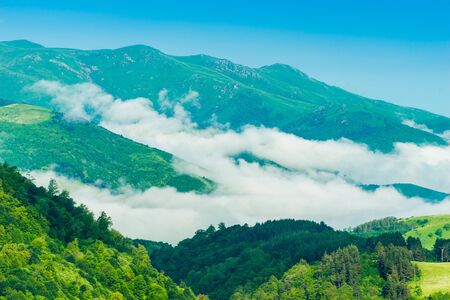 High green mountains of Armenia and clouds gathering in the valley of mountains