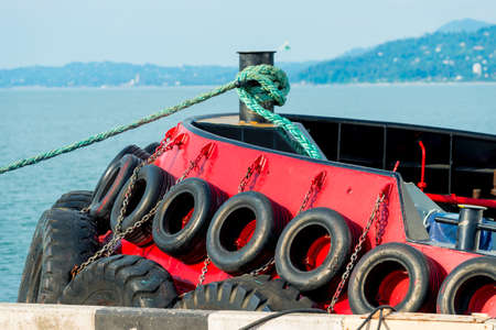 The side of the boat is hung with old tires to protect against impact.の写真素材
