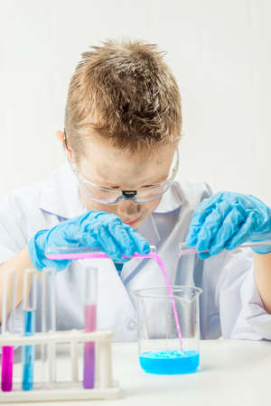 Funny boy dressed as chemist with dirty face after a failed experiment