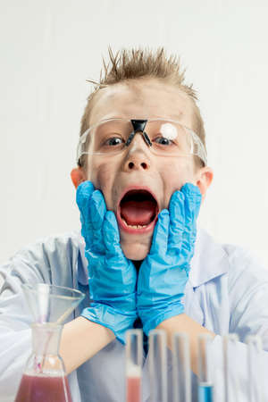 Funny boy dressed as chemist with dirty face after a failed experimentの写真素材