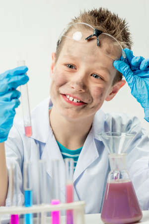 Funny boy dressed as chemist with dirty face after a failed experimentの写真素材