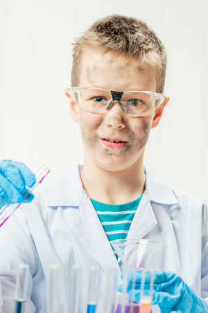 Funny boy dressed as chemist with dirty face after a failed experimentの写真素材