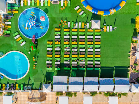 Aerial top view of hotel with swimming pool, sunbeds from above, tropical holiday resort, mediterranean paradise concept.のeditorial素材