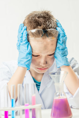 Funny boy dressed as chemist with dirty face after a failed experimentの写真素材