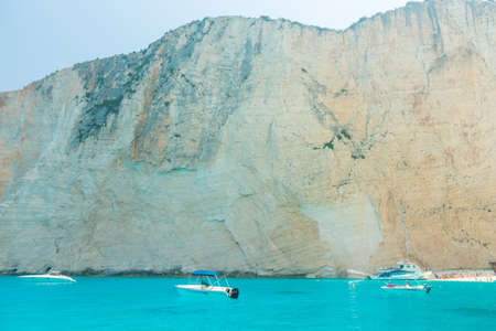 Beautiful sea coast with turquoise water, yacht and rocksの写真素材