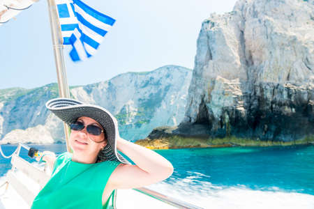 Relaxed woman in sun hat enjoying ocean voyage, sailing on the luxury yachtの写真素材