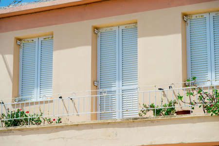 Rows of shutters on facade of typical old european houseの写真素材