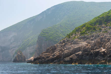 rocky coast of greek island and sea view, landscape greece view from boatの写真素材