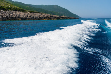 Tail wake on the water from the speedboat on a sunny day.の写真素材