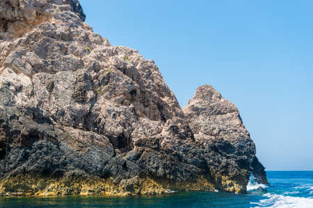 rocky coast of greek island and sea view, landscape greece view from boatの写真素材