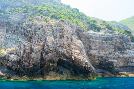 rocky coast of greek island and sea view, landscape greece view from boatの写真素材