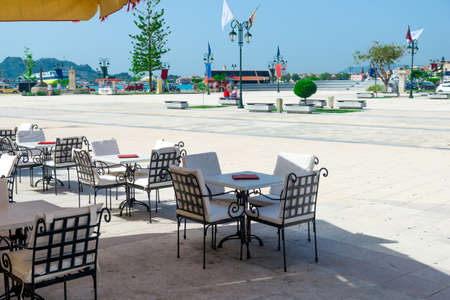Outdoor cafe on a street of typical greek in Greeceの写真素材