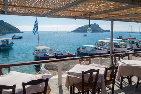 Table in restaurant with beautiful sea viewの写真素材