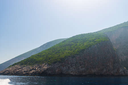 rocky coast of greek island and sea view, landscape greece view from boatの写真素材