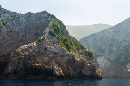 rocky coast of greek island and sea view, landscape greece view from boatの写真素材
