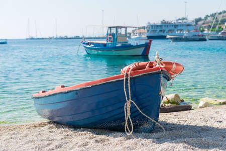 fishing boat on the beach of greece in sunny weatherの写真素材