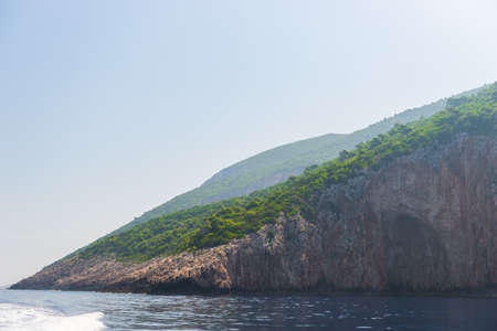 rocky coast of greek island and sea view, landscape greece view from boatの写真素材