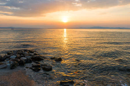 Evening sky with dramatic clouds over the sea. Dramatic sunset over the sea.