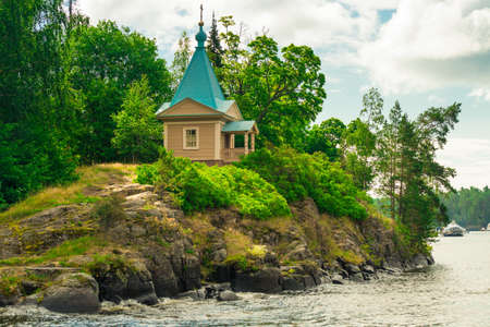 A beautiful small chapel on the shore of the lake on the island of Valaam. Karelia, Russiaの写真素材