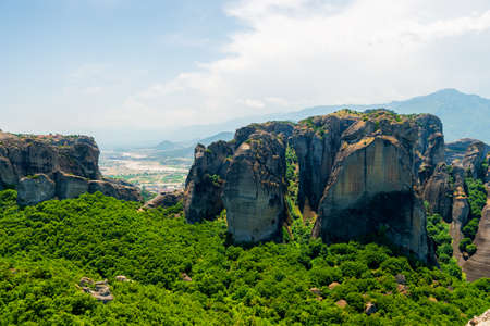 Huge gray rocks Meteors in Greece among green mountain forestの写真素材