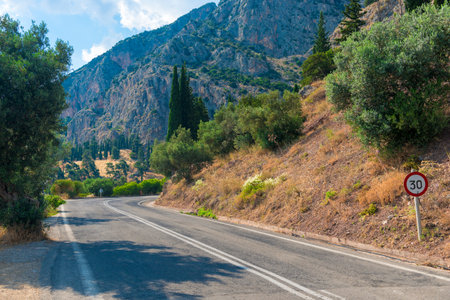 Highway road in the mountains, rocks on both sides with mountains in the background, Greeceの写真素材