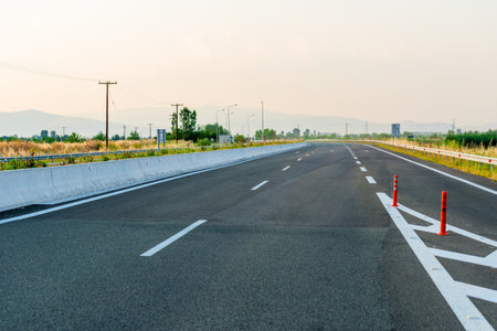 Driving car on a highway with view on scenic hills and mountains, European roadの写真素材