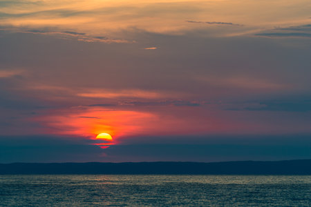 Evening sky with dramatic clouds over the sea. Dramatic sunset over the sea.の写真素材