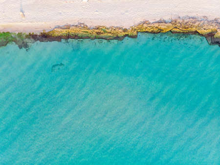 top view of turquoise sea and sandy beachの写真素材