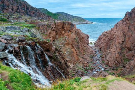 Mountain waterfall in the North of the Kola Peninsula. Waterfall in stone rocksの写真素材