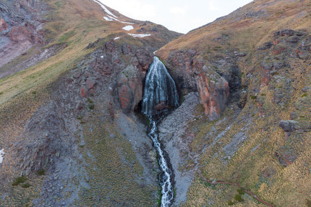 The stormy waterfall "maiden braids" falling from a vertical rocky wall. The mountains of the North Caucasus. Russia.の写真素材