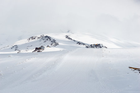 A ski slope in a snowstorm high in the mountains in bad weather. Elbrus. Caucasusの写真素材