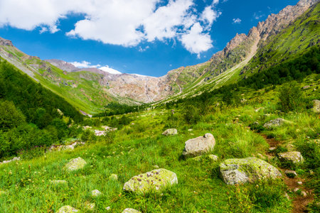 Beautiful high mountain landscape with green slopes and large stones. Caucasus, Elbrus region.の写真素材