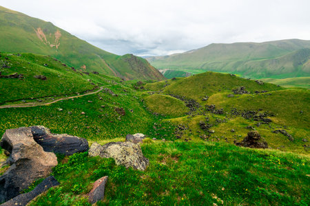 Dramatic scenic view of green mountains with lush grass in the Elbrus regionの写真素材