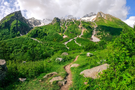Picturesque view with a path and a high beautiful majestic mountain with a system of waterfalls "three sisters". Caucasusの写真素材