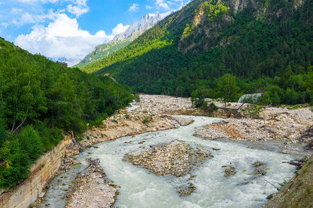 Picturesque mountain landscape of a stormy mountain river and its valley among green mountains. Caucasus, Elbrus regionの写真素材