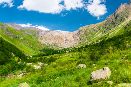 Beautiful high mountain landscape with green slopes and large stones. Caucasus, Elbrus region.の写真素材
